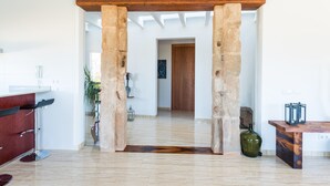 A modern kitchen with a stone archway leading to a hallway, a wooden ceiling, and a marble floor. - ES SERRAL - Villa with private pool in sa Pobla. Free WiFi (Sa Pobla)