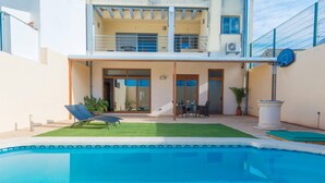 A residential building with a swimming pool, a balcony, and a patio area with outdoor furniture. - CAS PEIX - ADULTS ONLY  - Villa with private pool in Sa Pobla. Free WiFi (Sa Pobla)