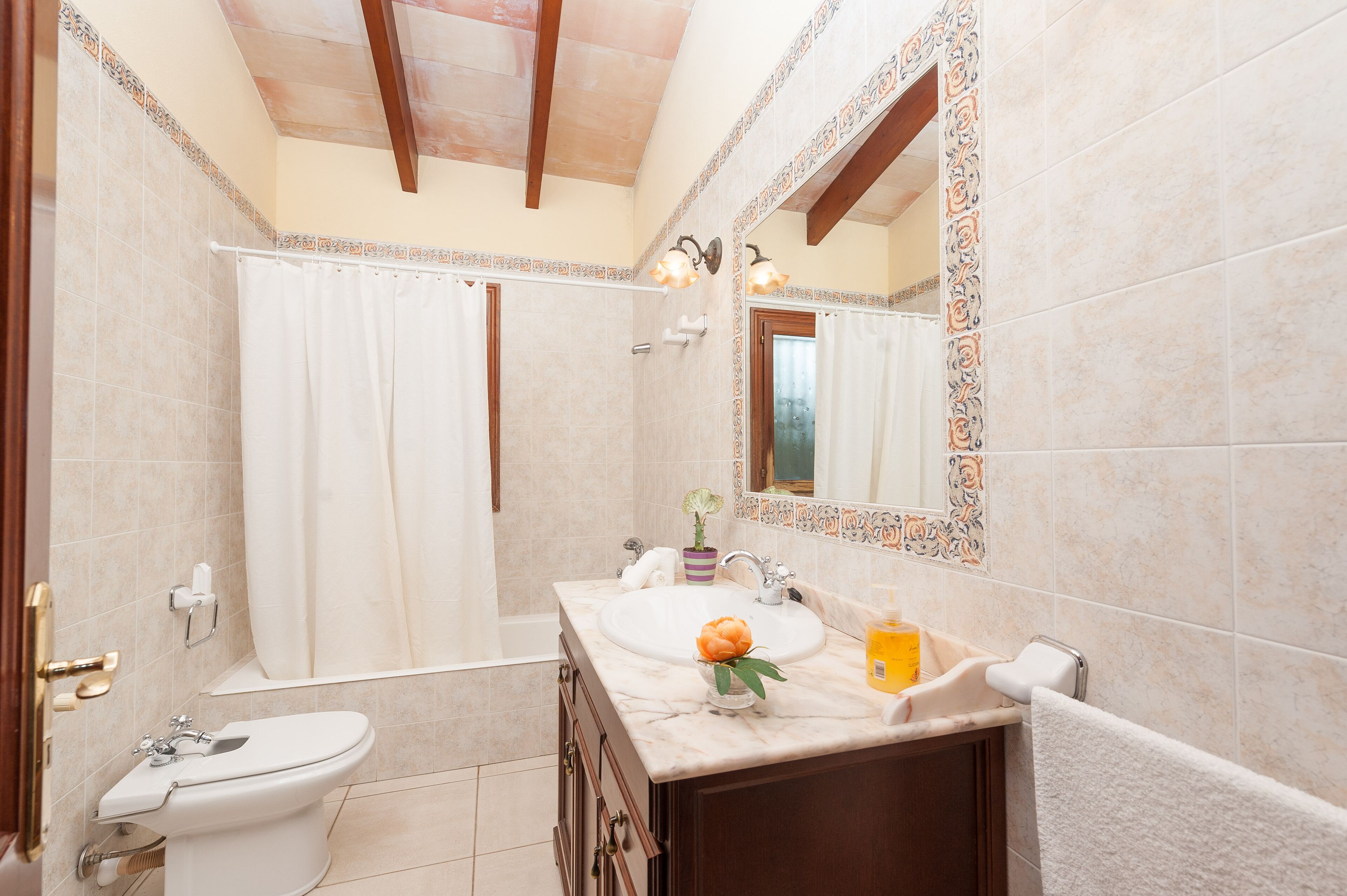 A bathroom with a bathtub, a sink, and a toilet.