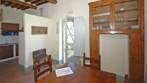 Una cocina con armarios de madera, un banco y una mesa de comedor con un menú.