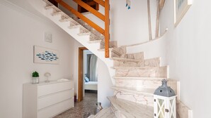 A staircase with marble steps and wooden handrails, leading to a bedroom with a bed and a window. - VILLA ISABEL - Great holiday home with several terraces near the beach. Free WiFi (Muro)