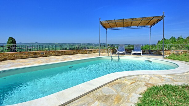 A swimming pool with a stone border, a covered seating area, and a view of the countryside. - Stunning private villa with private pool, WIFI, A/C, TV, terrace, pets allowed and panoramic view (Fontanella)