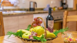 A bowl of fruit and a bottle of wine on a table in a kitchen. - CA SA NINA - Villa with private pool in Inca. Free WiFi (Inca)