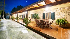 A stone building with a tiled patio, outdoor seating, and potted plants. - CA SA NINA - Villa with private pool in Inca. Free WiFi (Inca)