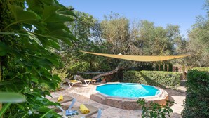 A swimming pool with lounge chairs and a canopy, surrounded by greenery. - SA MARJAL - Chalet with private pool in MURO. Free WiFi (Muro)