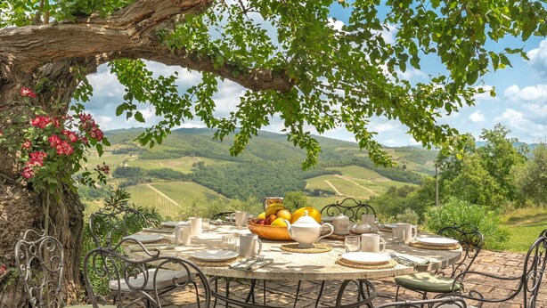 A round table set outdoors with a view of rolling hills. - Private Villa with WIFI, hot tub, private pool, TV, patio, panoramic view, close to Greve In Chianti (Lucarelli)