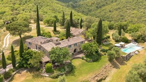 An aerial view of a stone villa with a swimming pool, surrounded by lush greenery and hills. - Private Villa with WIFI, hot tub, private pool, TV, patio, panoramic view, close to Greve In Chianti (Lucarelli)