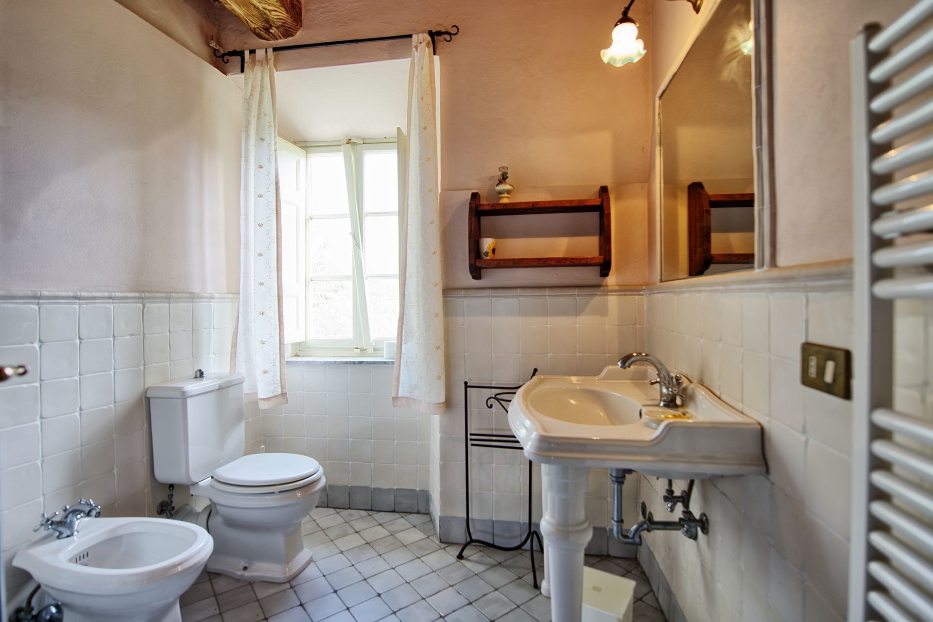 A bathroom with a toilet, bidet, and sink.