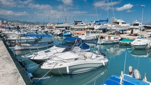 A marina with various boats docked, including sailboats and motorboats, under a clear sky. - CAN PONS - Chalet with terrace in Ca'n Picafort. Free WiFi (Can Picafort)