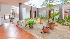 A spacious indoor area with a tiled floor, a staircase, and multiple potted plants. - TURIXANT DALT - Villa with private pool in Mancor De La Vall. Free WiFi (Mancor de la Vall)