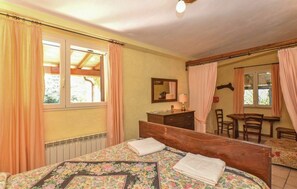 A bedroom with a bed, a dresser, a mirror, a desk with a chair, and a window with curtains. - Beautiful private villa for 7 people with private pool, WIFI, pets allowed and panoramic view (Pitigliano)