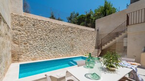 A stone wall, a swimming pool, and a staircase. - CAN DIANA - Vacation home with private pool in peaceful town. Free WiFi (Campanet)