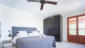 A bedroom with a bed, a ceiling fan, a wardrobe, and a door. - FINCA CAN POL - Villa with private pool in Inca. Free WiFi (inca)
