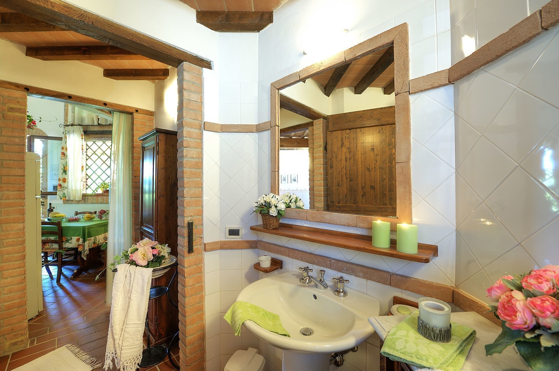 A bathroom with a large mirror, a sink, and a shower area.