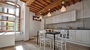 A modern kitchen with white cabinetry, a wooden ceiling, and pendant lighting. - Stunning private villa for 6 guests with private pool, WIFI, A/C, TV and panoramic view (San Miniato)