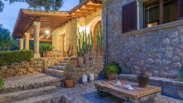 A stone building with a wooden pergola, steps leading to a door, and potted plants. - SA GARRIGA - Villa with private pool in INCA. Free WiFi (Inca)