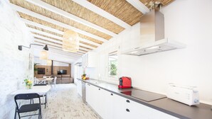 A modern kitchen with white cabinets, a black countertop, and a red toaster. - CAN JOAN DES FORN - House with private pool in Inca. Free WiFi (Inca)