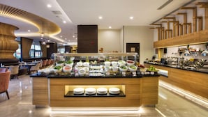 A modern breakfast bar with a variety of food items and a coffee station. - Hilton Garden Inn Isparta (Isparta)
