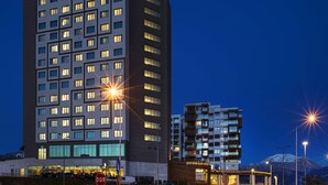 A multi-story hotel with a modern design, featuring a prominent sign at the top. - Hilton Garden Inn Isparta (Isparta)