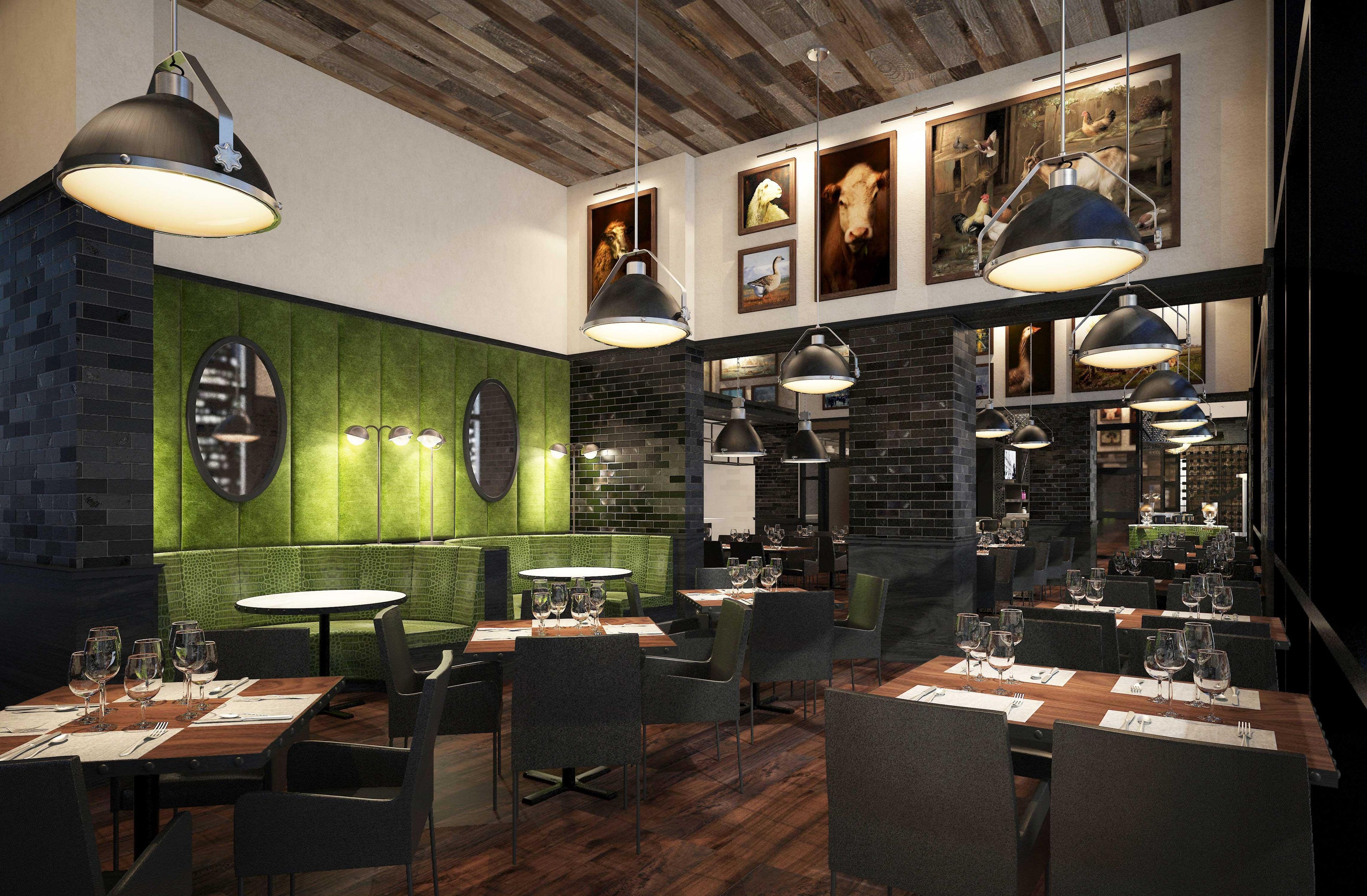 L’intérieur d’un restaurant présente un plafond en bois, des banquettes recouvertes d’un tissu vert et de nombreuses tables ornées de verres à vin.