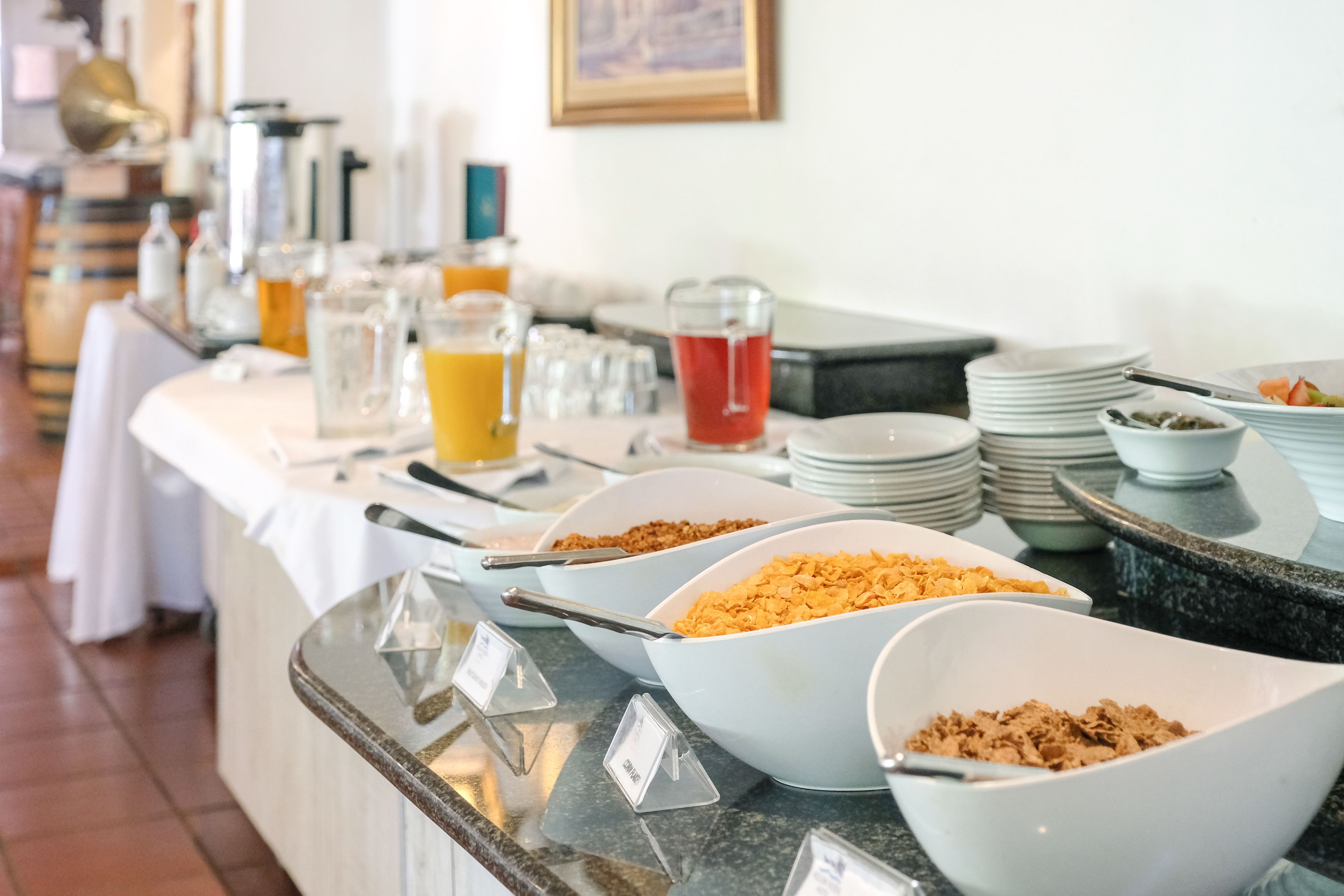 A buffet with various food items and beverages.
