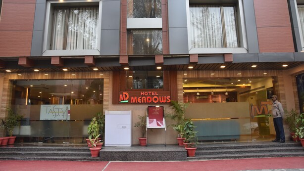 A hotel entrance with a sign reading "Hotel Meadows." - Meadows (Varanasi)