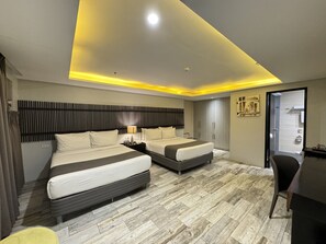 A modern hotel room with two beds, a desk, and a chair. - 1A Express Hotel (Cagayan de Oro)