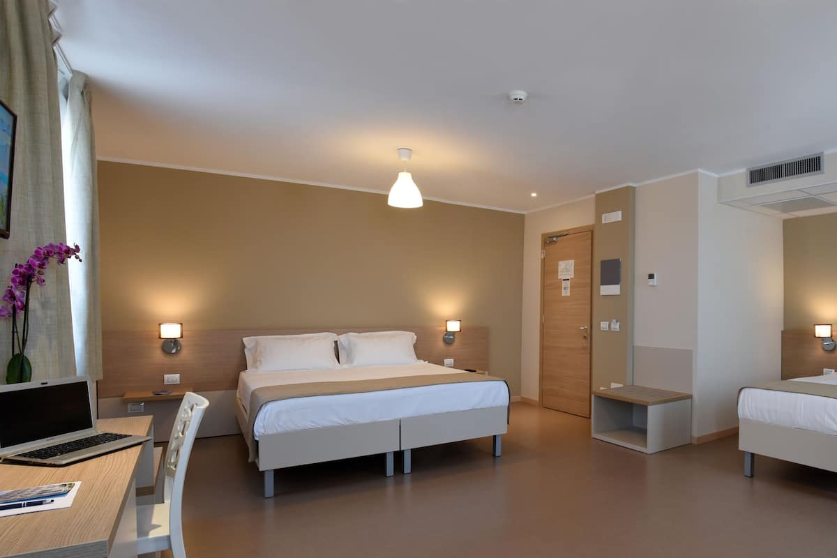 deluxe triple room | desk, blackout curtains, soundproofing, cots/infant beds