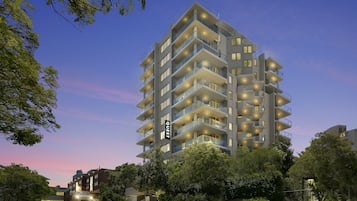 Experience the contemporary architecture of this hotel, featuring a prominent entrance and stylish balconies with glass railings.