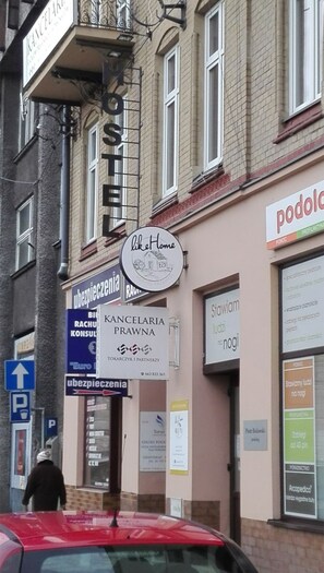 A building with multiple signs, including 'Kancelaria Prawna' and 'Like Home'. - HOSTEL likeHome (Przemysl)