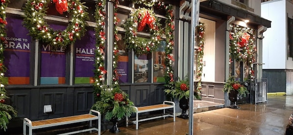 A hotel entrance decorated with festive wreaths and lights. - Granville Hall Residence (Halifax)