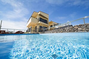 A modern two-story building with a swimming pool in front. - GeumDanyeong (Jeju City)