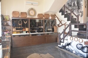 A jewelry display with various items, a clock, and a staircase with a mural. - Jilufugan B&B (Jinfeng)