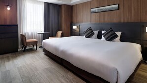 A hotel room with a large bed, a chair, a small table, and a cityscape painting on the wall. - Mitsui Garden Hotel Otemachi Tokyo  (Tokyo)