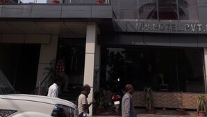 A modern building with a prominent entrance, large windows, and a sign indicating it is a hotel. - M S Hotel (Bhagalpur)
