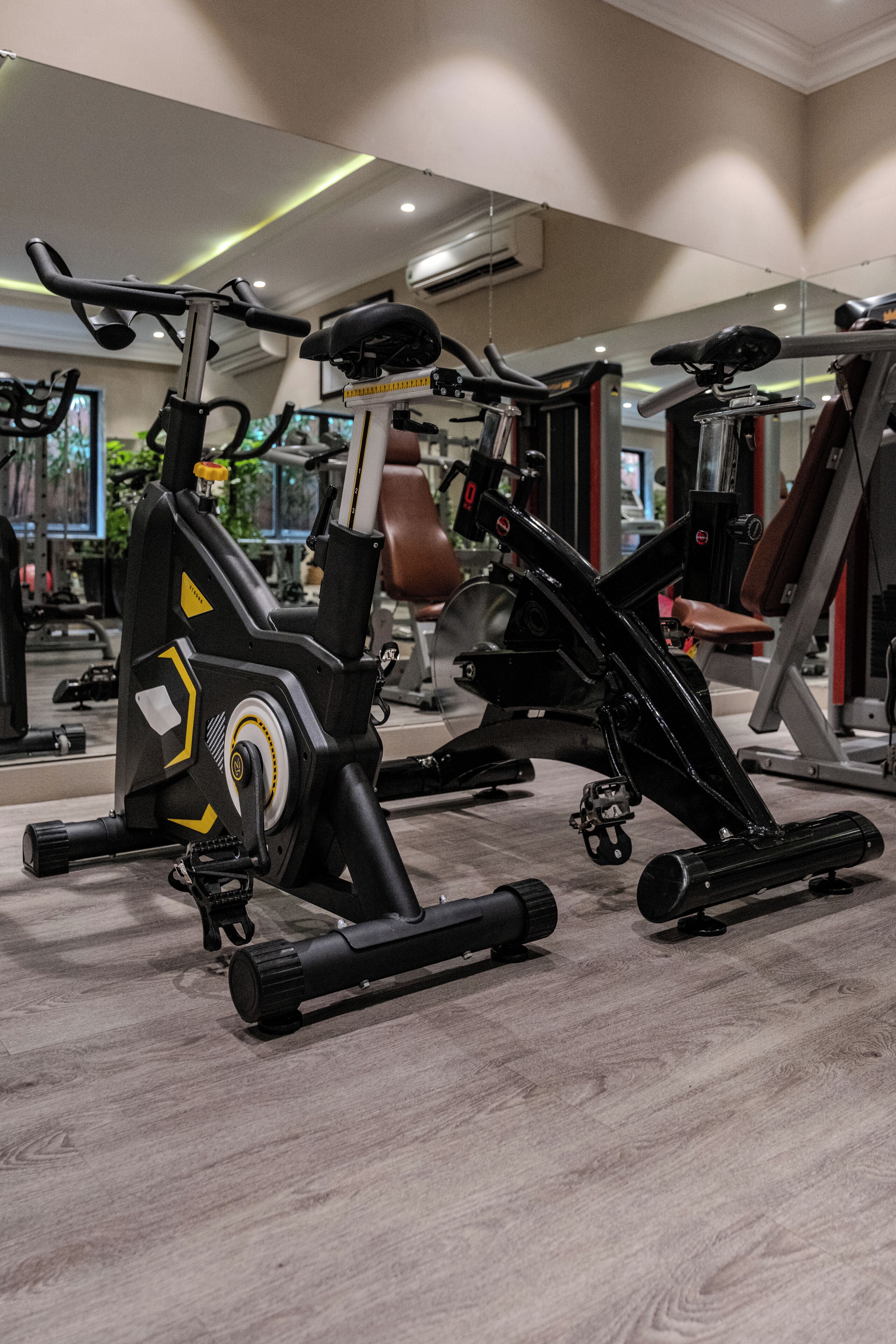 A gym with exercise equipment, including an elliptical and a stationary bike.