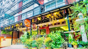 A hotel with a sign reading "The K6" and multiple potted plants in front. - The Konnect Hotel (Bangkok)