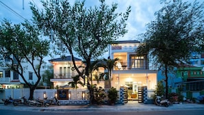 A two-story building with a balcony, a gated entrance, and a signboard. - Horizon Homestay (Da Nang)