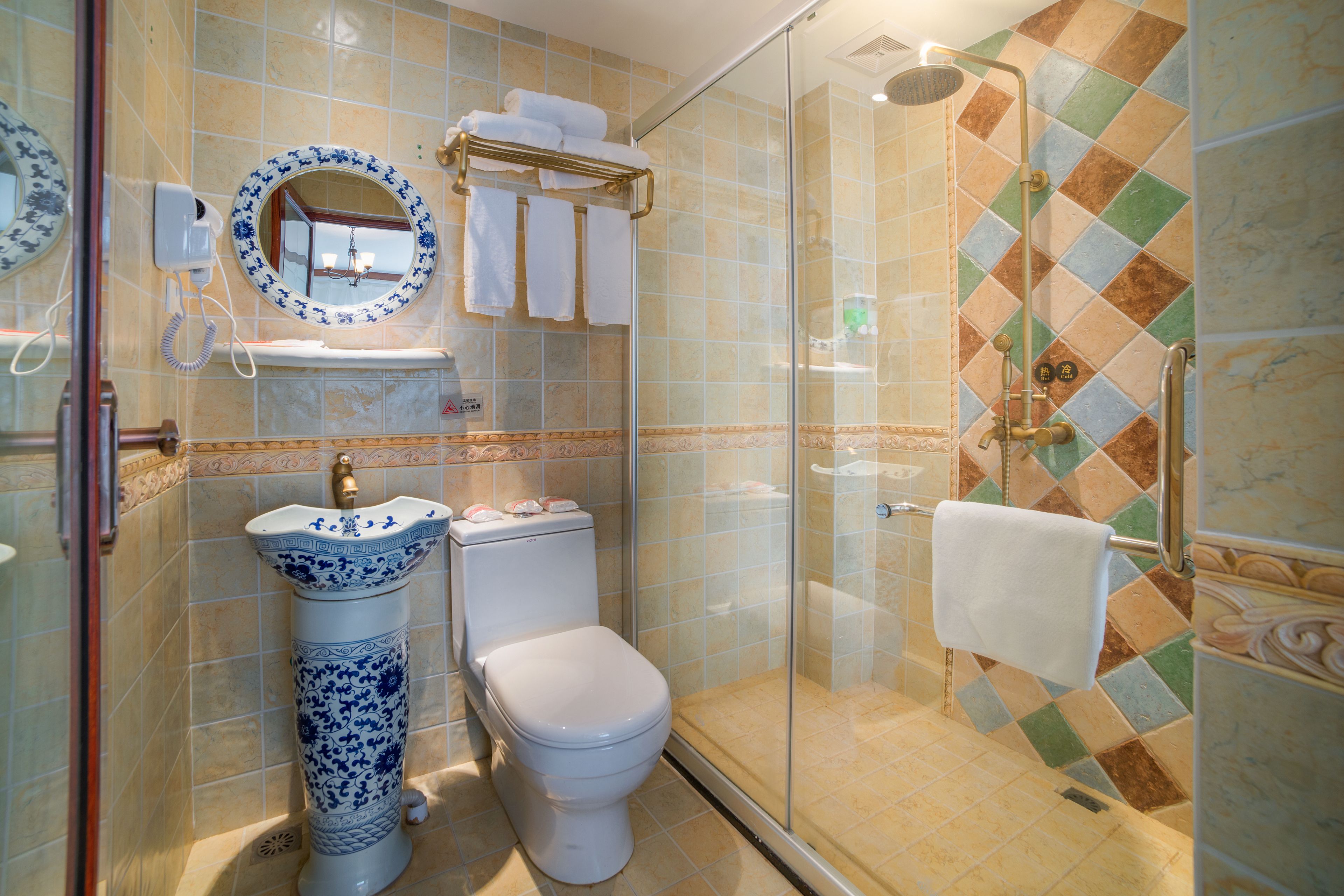 A bathroom with a toilet, sink, and shower.