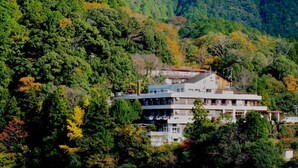 A multi-story building surrounded by dense forest. - Yunominesou (Tanabe)