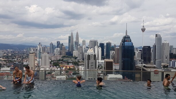 A rooftop infinity pool with a city skyline view, including high-rise buildings and a tower. - Regalia Studio 109 Suites (Kuala Lumpur)