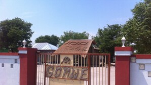 A gated entrance with a sign that reads "GOTINE". - Gomwe Guest Inn (Nata)