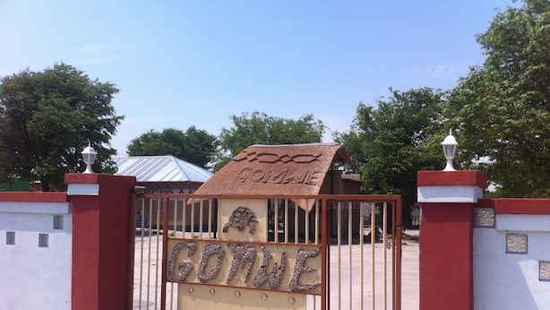 A gated entrance with a sign that reads "GOTINE".