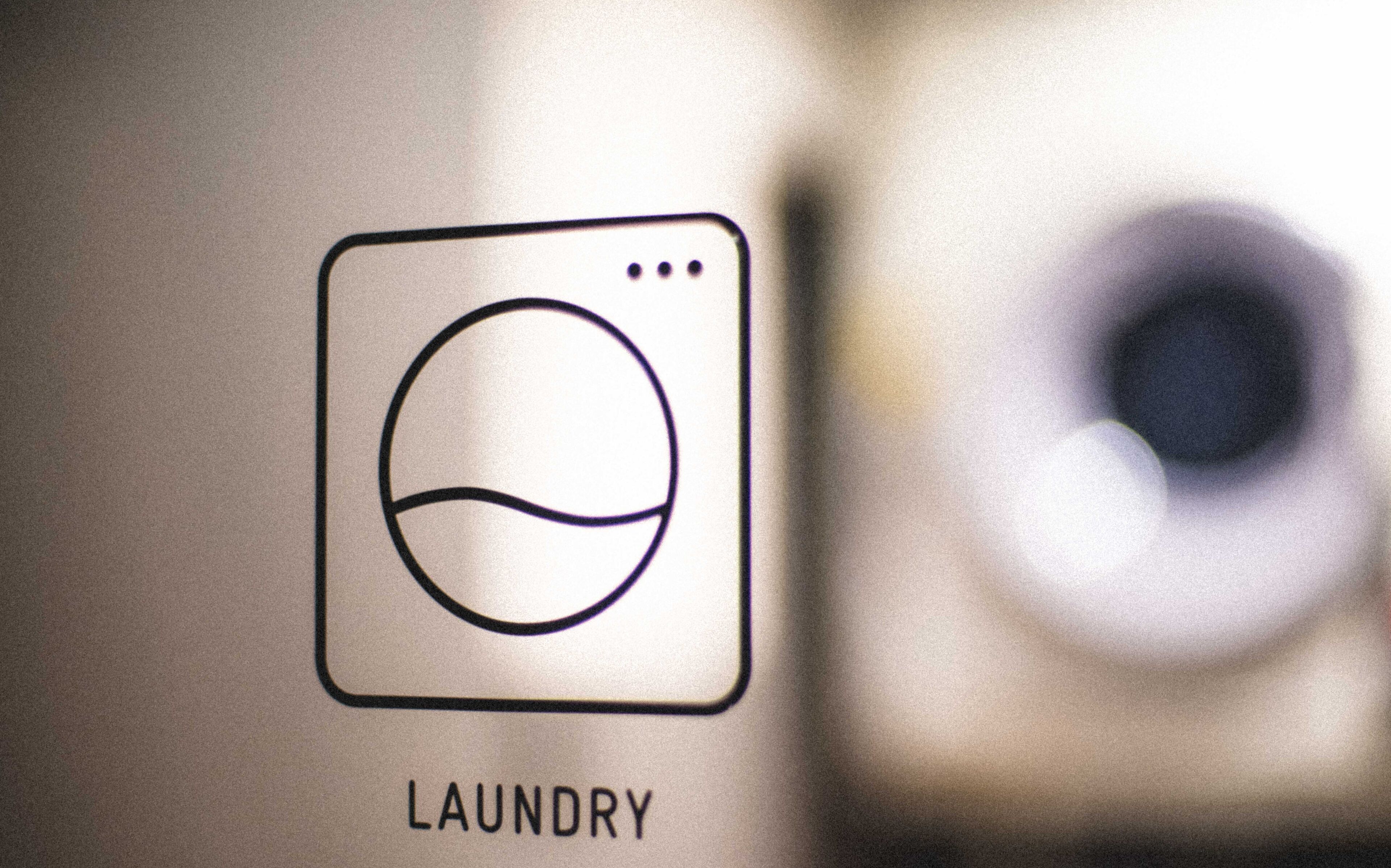 A laundry symbol with the word "LAUNDRY" below it.