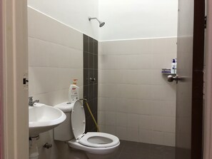 A small, clean bathroom with a toilet, sink, and shower. - Seri Rendang Homestay Pekan Pahang (Pekan)