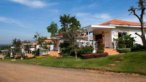 A two-story house with a red-tiled roof, a covered porch, and a well-maintained lawn. - Keawanongburi Resort (Nakhon Ratchasima)