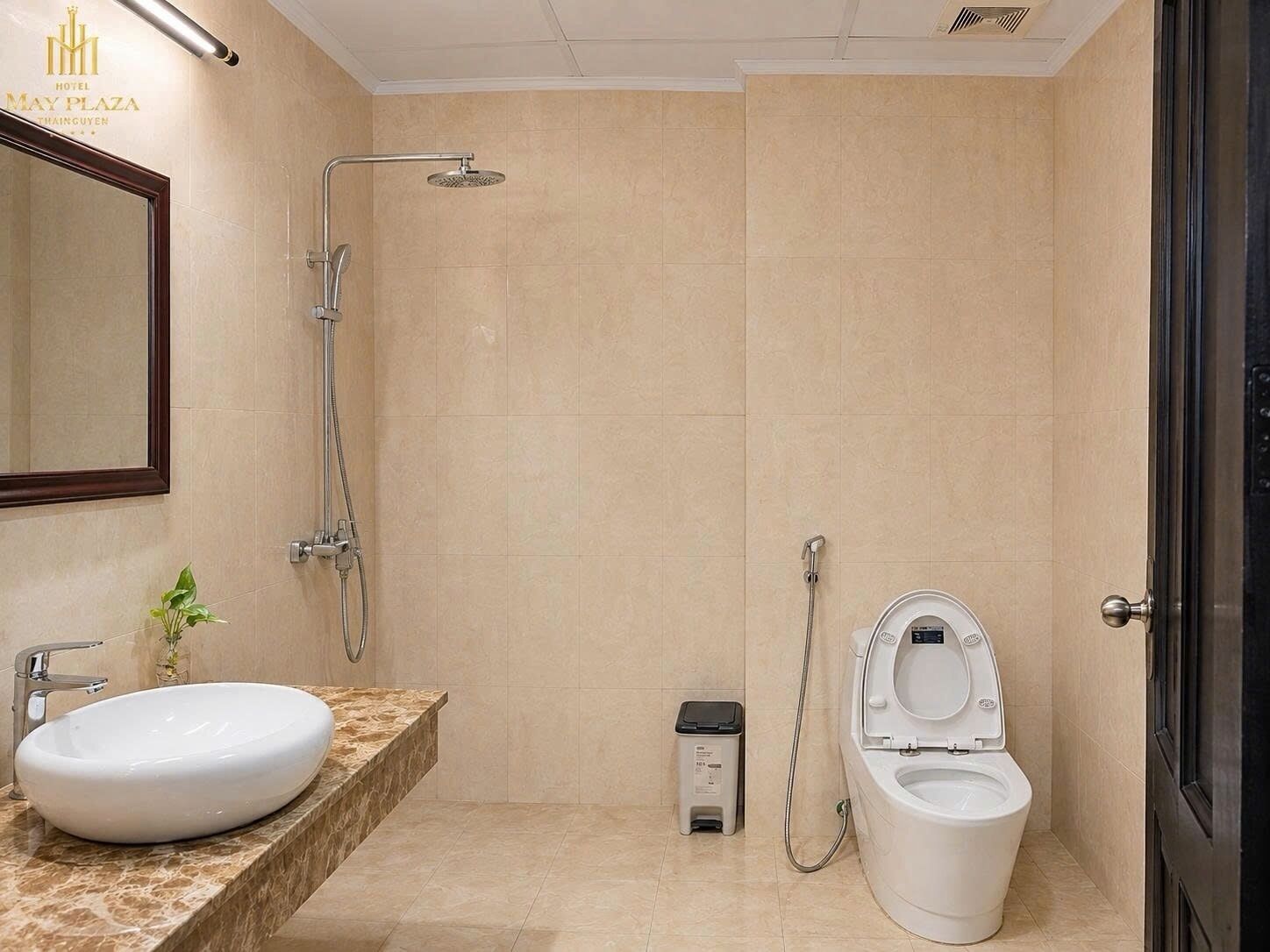 A modern bathroom with a large sink, a toilet, and a shower.