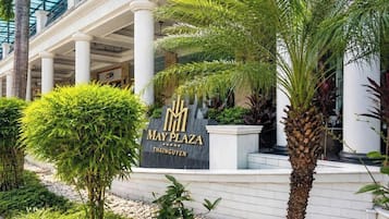 A sign for May Plaza in Thanguyen with a classical architectural style, including columns and a covered entrance.