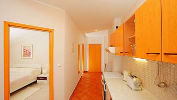 Apartamento, 1 quarto, sacada, vista para o mar | Cozinha americana privada | Geladeira, fogão, cooktop, cafeteira/chaleira