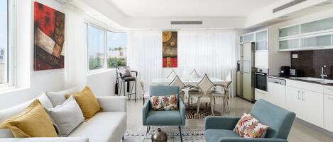 Un salon moderne avec un canapé, des fauteuils et un coin repas agrémenté d’un tapis à motifs zébrés.